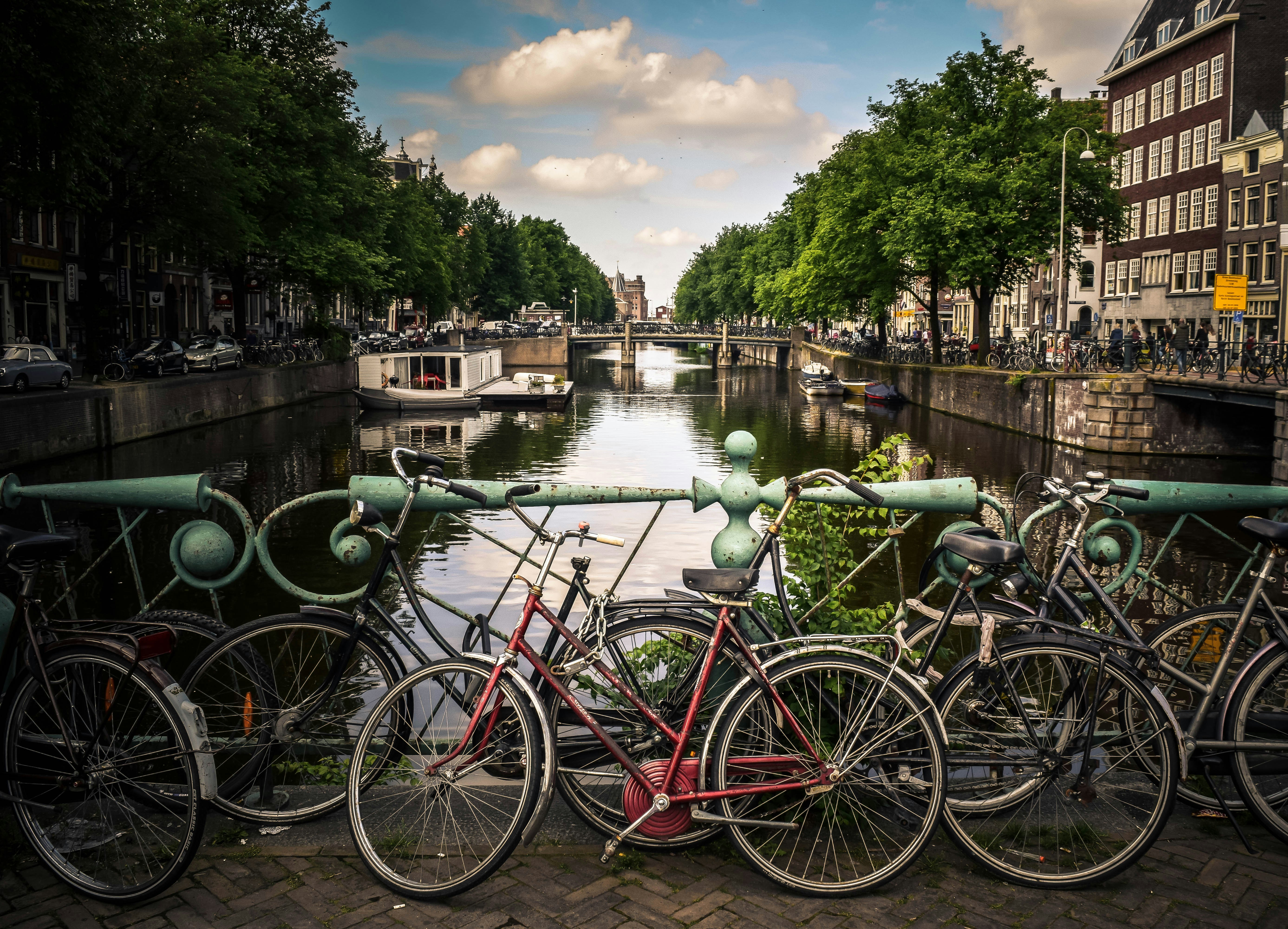 Amsterdam canal bridge with bicycles and water in the background