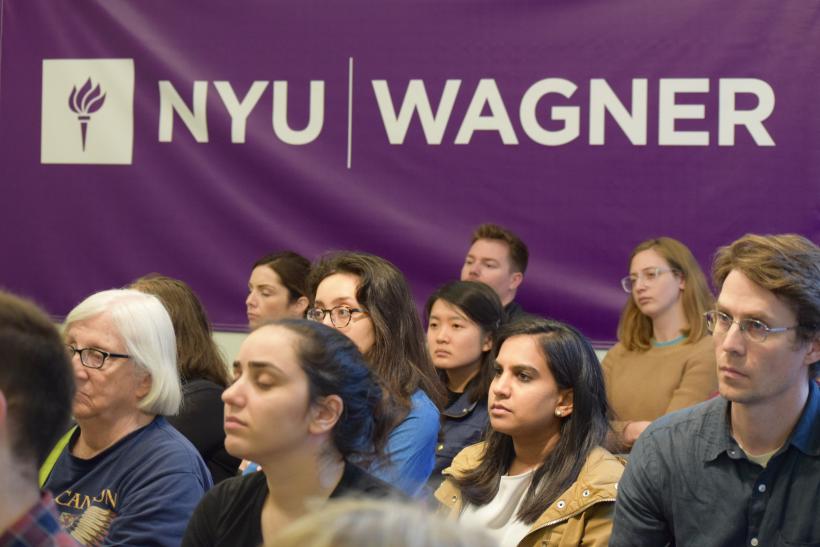 People seated against "NYU Wagner" banner