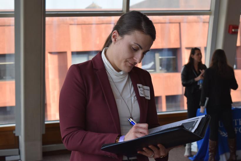 A NYU Wagner student takes notes during the career expo.