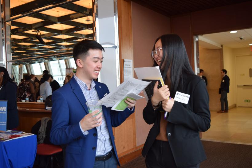 Two students laugh at the career expo.
