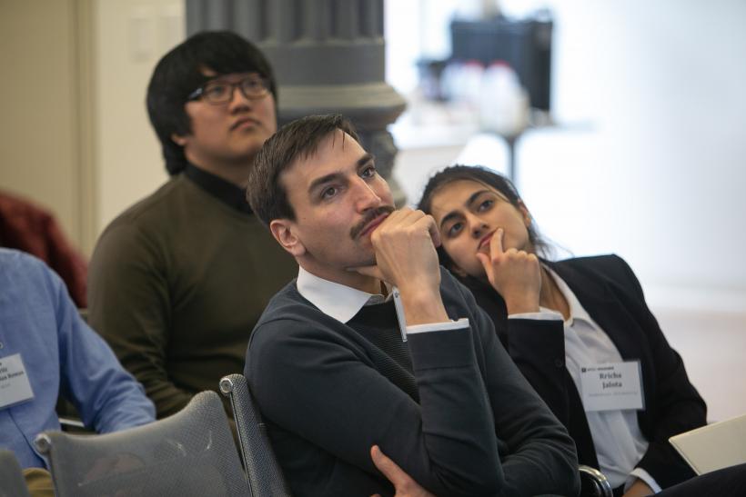 Team representatives watch the presentations during the competition