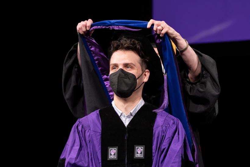 PhD graduate being hooded