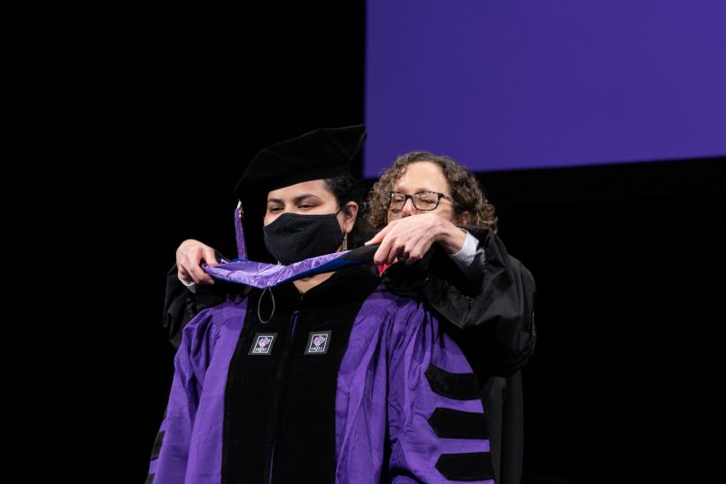 A PhD student being hooded
