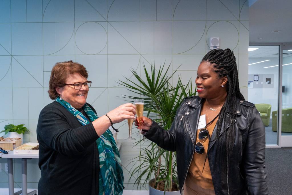 two people clinking champagne glasses 