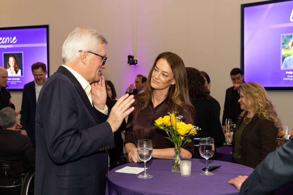 two people talking at high top table
