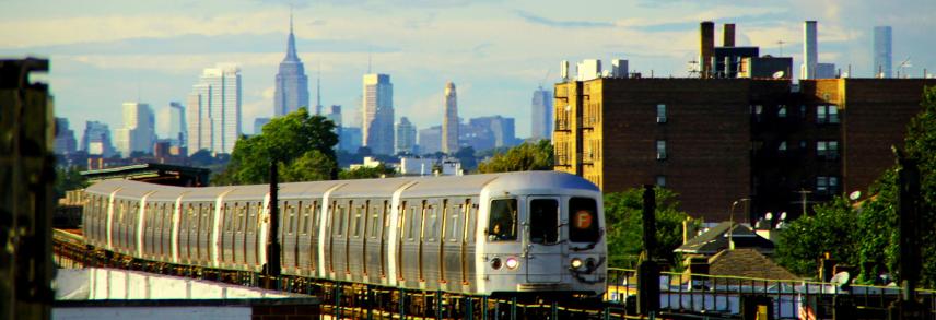 F train subway with NYC skyline