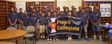 Prep@Collegiate students photographed with the school's banner. 