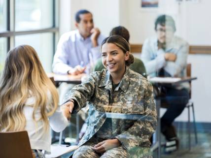 veteran shaking woman's hand