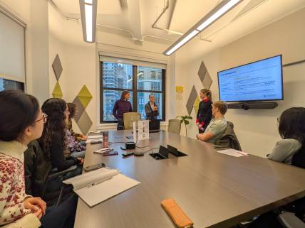 students listening to speakers in conference room 