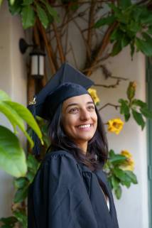 Pictured is a headshot of a young woman wearing graduation attire.