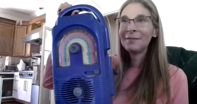 Alicia Polak in 2023 holding the same radio that impacted her journey over 20 years ago.